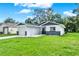Well-maintained home with a green lawn, and a driveway leading to a single-car garage at 324 James Pl, St Cloud, FL 34769