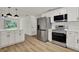 Bright, updated kitchen featuring stainless steel appliances, white cabinetry, and modern finishes at 324 James Pl, St Cloud, FL 34769