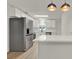 Modern kitchen with stainless steel appliances, white cabinets, and an adjacent breakfast bar at 324 James Pl, St Cloud, FL 34769