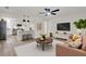 Cozy living room with open floor plan, stylish furnishings, and modern lighting fixtures at 324 James Pl, St Cloud, FL 34769
