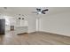 Bright living room featuring hardwood floors, a modern ceiling fan, and an open layout at 324 James Pl, St Cloud, FL 34769