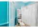 Bright bathroom features a toilet with cabinet, shower and a light blue painted walls at 3250 Sawgrass Creek Cir, St Cloud, FL 34772
