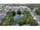 Aerial view of community with pond, fountain, and well-maintained landscaping at 335 Lansbrook Ln, Winter Springs, FL 32708