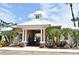 Community clubhouse featuring tropical landscaping and a gated entrance at 335 Lansbrook Ln, Winter Springs, FL 32708