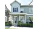 Charming two-story townhouse with a welcoming front porch and well-maintained landscaping at 335 Lansbrook Ln, Winter Springs, FL 32708