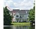 Waterfront townhouse with blue shutters and landscaping at 335 Lansbrook Ln, Winter Springs, FL 32708