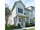 Charming two-story townhouse with a welcoming front porch and well-maintained landscaping at 335 Lansbrook Ln, Winter Springs, FL 32708