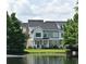 Waterfront townhouse with blue shutters and landscaping at 335 Lansbrook Ln, Winter Springs, FL 32708