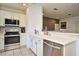 This well-lit kitchen showcases stainless steel appliances, elegant cabinetry, and modern countertops at 335 Lansbrook Ln, Winter Springs, FL 32708