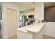 Bright kitchen featuring stainless steel appliances, white cabinets, and a convenient breakfast bar at 335 Lansbrook Ln, Winter Springs, FL 32708