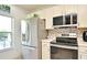 Modern kitchen featuring a stainless steel refrigerator, sleek appliances, and stylish backsplash at 335 Lansbrook Ln, Winter Springs, FL 32708