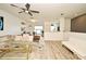 Open-concept living room with a sofa, coffee table, and wood floors at 335 Lansbrook Ln, Winter Springs, FL 32708