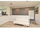 Additional seating with futon in a naturally lit living space with gray accent wall and modern flooring at 335 Lansbrook Ln, Winter Springs, FL 32708