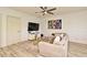 Inviting living room featuring plush sofa, decorative rug, a sleek TV console, and contemporary decor accents at 335 Lansbrook Ln, Winter Springs, FL 32708