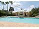 Inviting community pool and clubhouse with palm trees, perfect for relaxation and enjoying the Florida sunshine at 335 Lansbrook Ln, Winter Springs, FL 32708