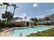 Relaxing community pool with nearby lounge chairs and lush landscaping creating a tranquil setting at 335 Lansbrook Ln, Winter Springs, FL 32708