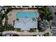 Aerial view of a community pool with sun loungers and lush tropical landscaping at 335 Lansbrook Ln, Winter Springs, FL 32708