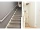 Interior staircase featuring carpeted steps and a white handrail at 335 Lansbrook Ln, Winter Springs, FL 32708