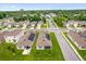 Neighborhood aerial view showcasing houses with solar panels and green lawns at 336 Pelham Park Dr, Deland, FL 32720