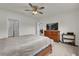 Bedroom with a wooden dresser, television, and adjoining bathroom, offering a private retreat at 336 Pelham Park Dr, Deland, FL 32720