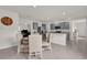 Open-concept dining area with gray cabinets, stainless steel appliances, and a round table at 336 Pelham Park Dr, Deland, FL 32720