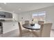 Bright dining area featuring a round table with seating for four, adjacent to the kitchen at 336 Pelham Park Dr, Deland, FL 32720