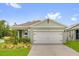 Charming single-story home with a two-car garage and beautifully landscaped front yard at 336 Pelham Park Dr, Deland, FL 32720