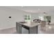 Open kitchen with island and dining area, seamlessly flowing into the living space at 336 Pelham Park Dr, Deland, FL 32720