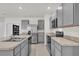 Contemporary kitchen with gray cabinets, stainless steel appliances and a tile floor at 336 Pelham Park Dr, Deland, FL 32720
