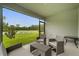 Screened patio showcasing seating area with serene green space views at 336 Pelham Park Dr, Deland, FL 32720