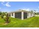 Home back exterior featuring a screened lanai and well-maintained lawn at 336 Pelham Park Dr, Deland, FL 32720