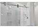 Modern bathroom shower featuring sliding glass door and built-in shelving at 336 Pelham Park Dr, Deland, FL 32720