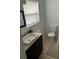 Bathroom with a modern vanity, toilet, tiled floor, and a window above the vanity at 3410 Calumet Dr, Orlando, FL 32810