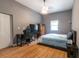 Bedroom with wood floors, a gaming chair, and a ceiling fan at 3410 Calumet Dr, Orlando, FL 32810