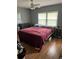 Bedroom with hardwood floors, a large window, and neutral-colored walls at 3410 Calumet Dr, Orlando, FL 32810
