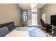 Bedroom with wood floors, a gaming chair, a bed, and a gray wall at 3410 Calumet Dr, Orlando, FL 32810