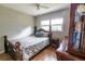 Charming bedroom featuring hardwood floors, natural light, a comfy bed, and stylish furnishings at 3410 Calumet Dr, Orlando, FL 32810