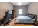 Bedroom with wood floors, a gaming chair, and a dark gray wall at 3410 Calumet Dr, Orlando, FL 32810