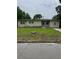 Single story home featuring a yellow-painted exterior with a well-maintained lawn and some plants at 3410 Calumet Dr, Orlando, FL 32810