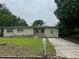 Single-story home with neutral paint, front yard, driveway and an inviting curb appeal at 3410 Calumet Dr, Orlando, FL 32810