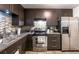 Contemporary kitchen with stainless steel oven, fridge, custom cabinets, and tile backsplash at 3410 Calumet Dr, Orlando, FL 32810