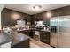 Modern kitchen featuring stainless steel appliances, dark brown cabinets, and sleek countertops at 3410 Calumet Dr, Orlando, FL 32810