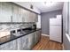 Kitchenette with gray cabinets, a stainless steel sink, a backsplash, and wood floors at 3410 Calumet Dr, Orlando, FL 32810