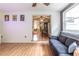 Comfortable living room with hardwood floors, seamless layout, and filled with natural light from large windows at 3410 Calumet Dr, Orlando, FL 32810