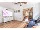 Open-concept living room with light wood floors, large TV, and a view into the dining area at 3410 Calumet Dr, Orlando, FL 32810