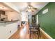 Expansive living space with dark wood-look floors connecting kitchen and dining areas at 3410 Calumet Dr, Orlando, FL 32810