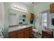 Modern bathroom with grey vanity, laminate floors, and a walk-in shower at 3562 Foxchase Dr, Clermont, FL 34711