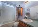 Bright bathroom with tile flooring, shower-tub combo, wooden vanity, and medicine cabinet at 3562 Foxchase Dr, Clermont, FL 34711