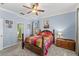 Spacious primary bedroom with blue walls, a ceiling fan, and traditional furniture at 3562 Foxchase Dr, Clermont, FL 34711