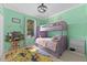 Colorful bedroom with bunk beds, carpet, and bright green walls at 3562 Foxchase Dr, Clermont, FL 34711